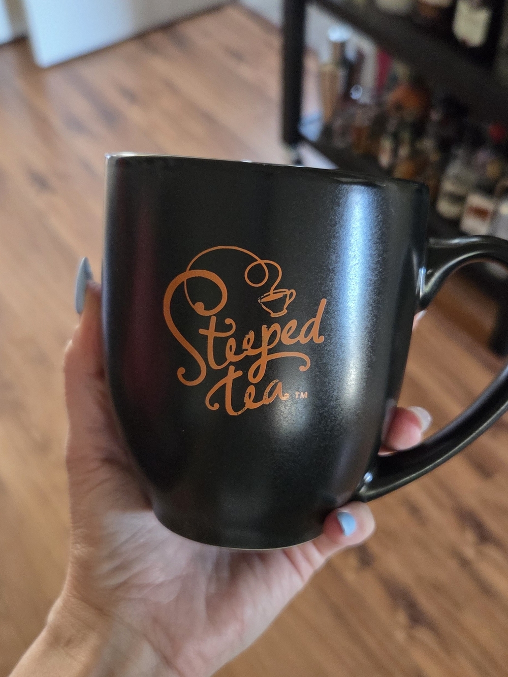 Steeped Tea Black Ceramic Mug with Orange Logo